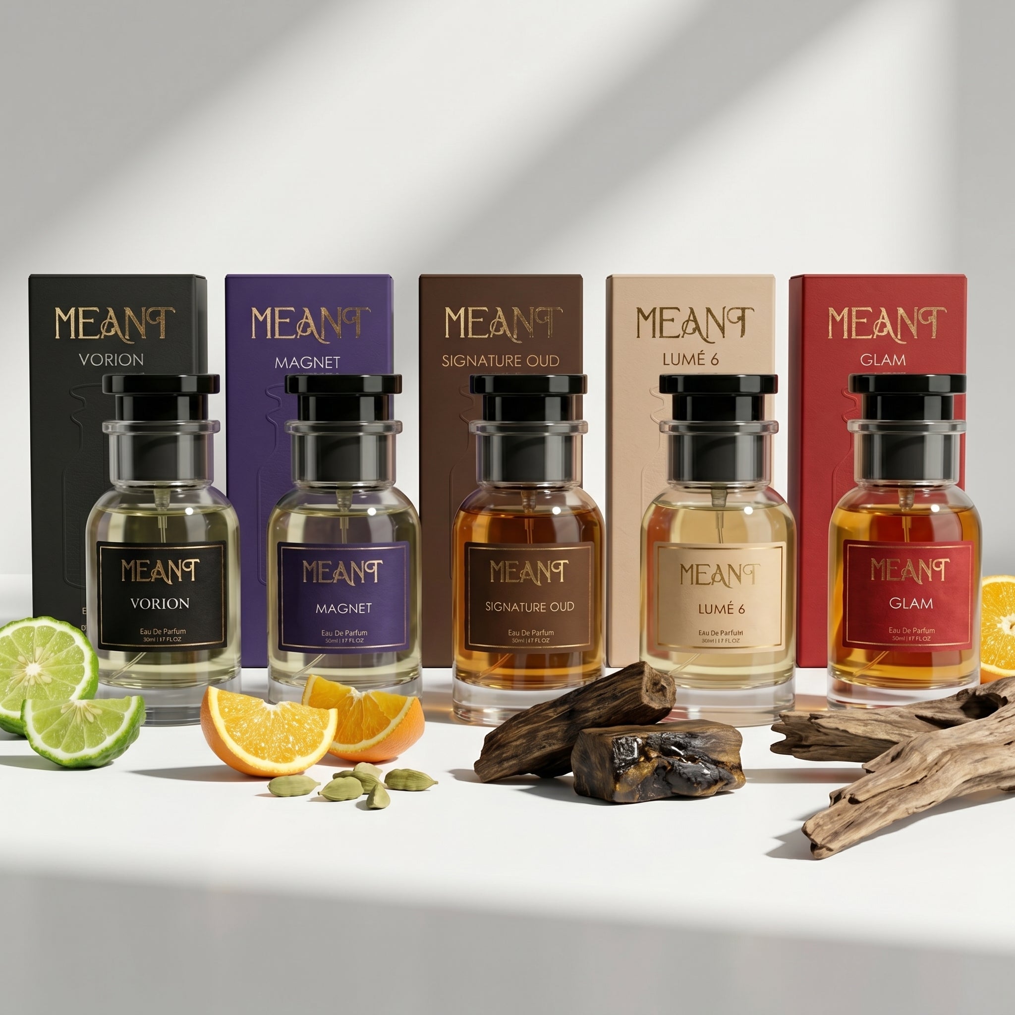 Five MEANT perfume bottles with corresponding boxes on a white background with citrus, cardamom, driftwood and oud elements.