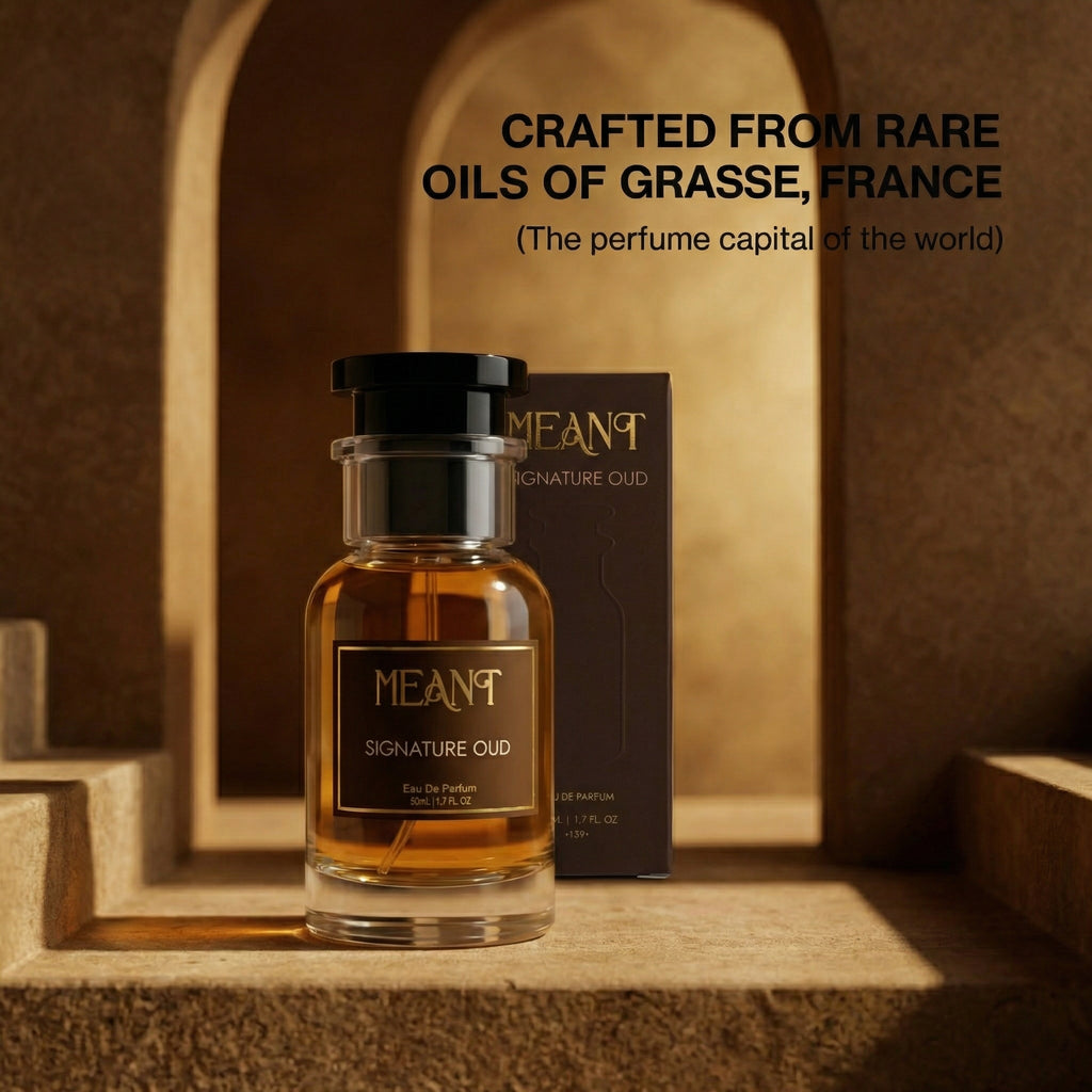 Perfume bottle of MEANT Signature oud perfume with packaging on a textured surface, text about Grasse, France (the perfume capital of the world).