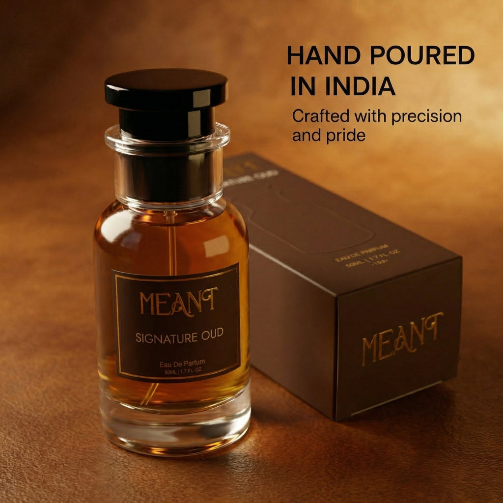 MEANT Signature Oud perfume with packaging on a brown background showing its hand poured in India quality.