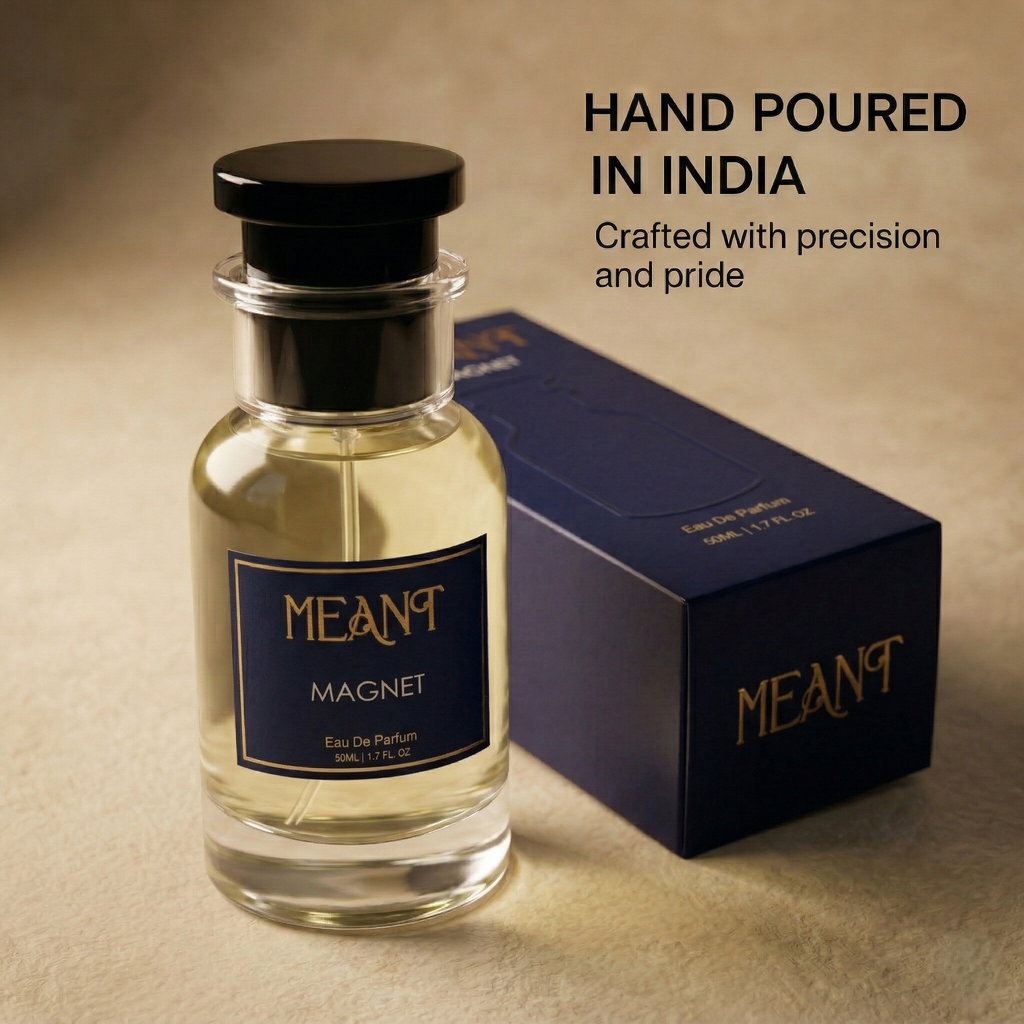 Perfume bottle and packaging with 'MEANT Magnet' branding on a beige background showing its hand poured in India uniqueness.