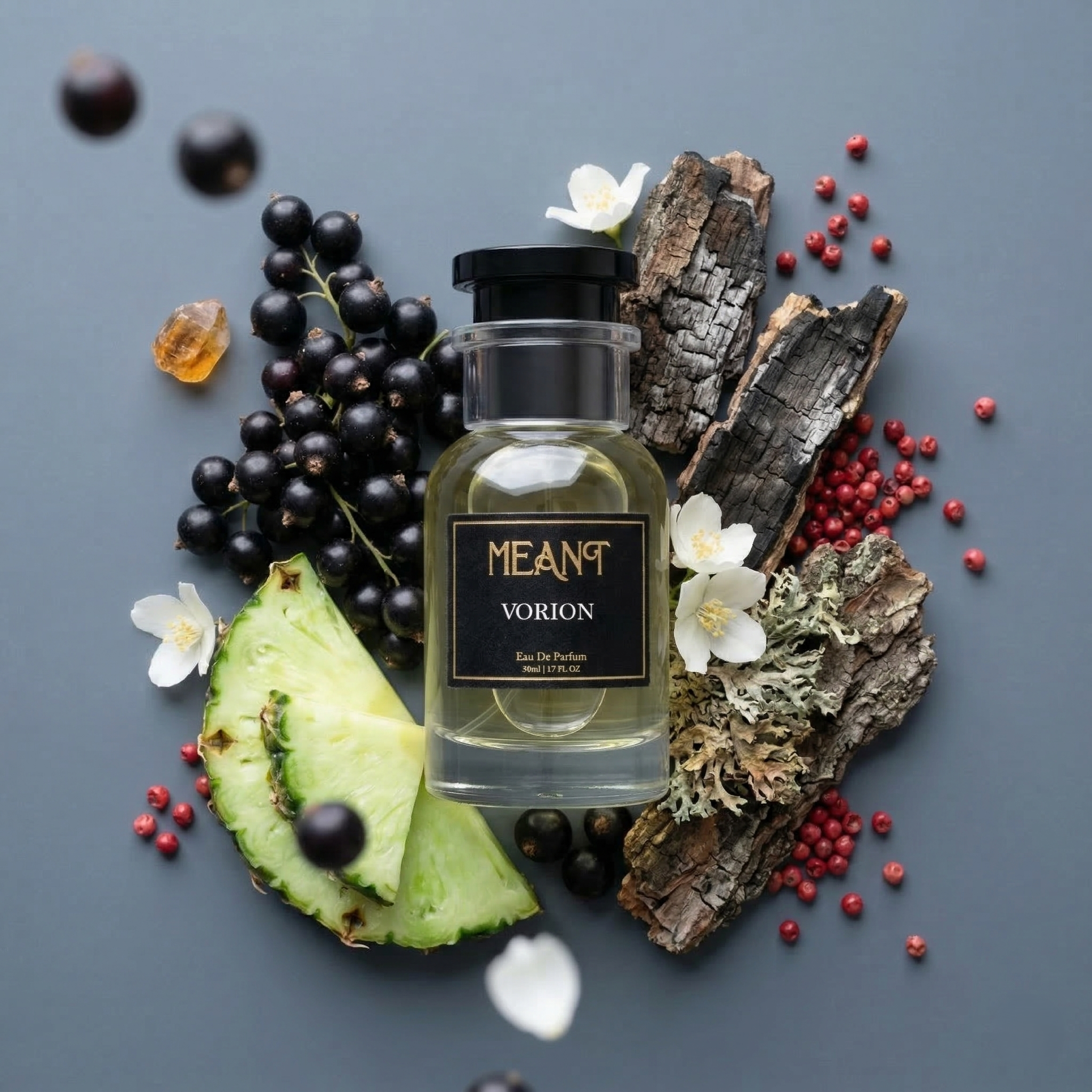 MEANT Vorion perfume bottle surrounded by fruits and natural elements on a gray background