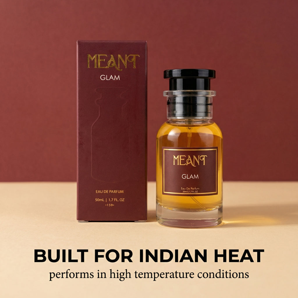 Meant Glam perfume bottle and packaging on a beige surface with a red background showing it's built to handle Indian heat.