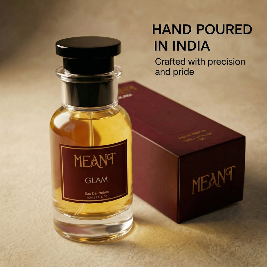 Perfume bottle and packaging with 'MEANT Glam' branding on a beige background showing its hand poured in India & precision speciality.