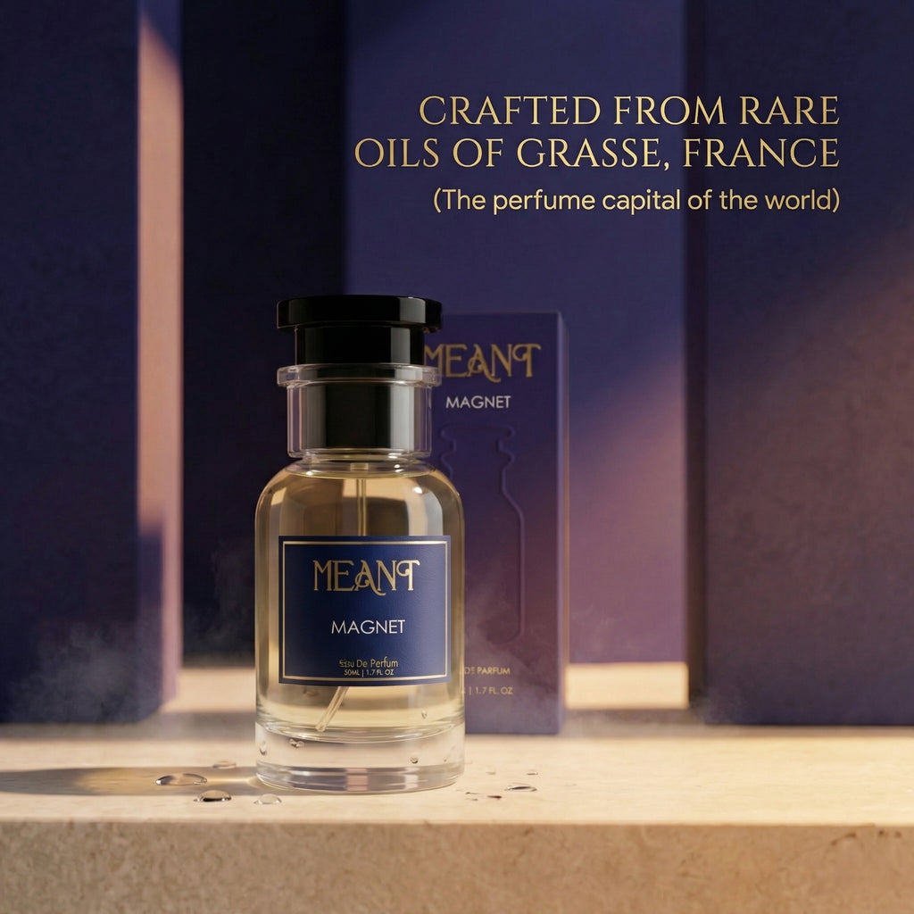 MEANT Magnet perfume bottle with packaging on a wooden surface, text about its made from Grasse, France rare oils.