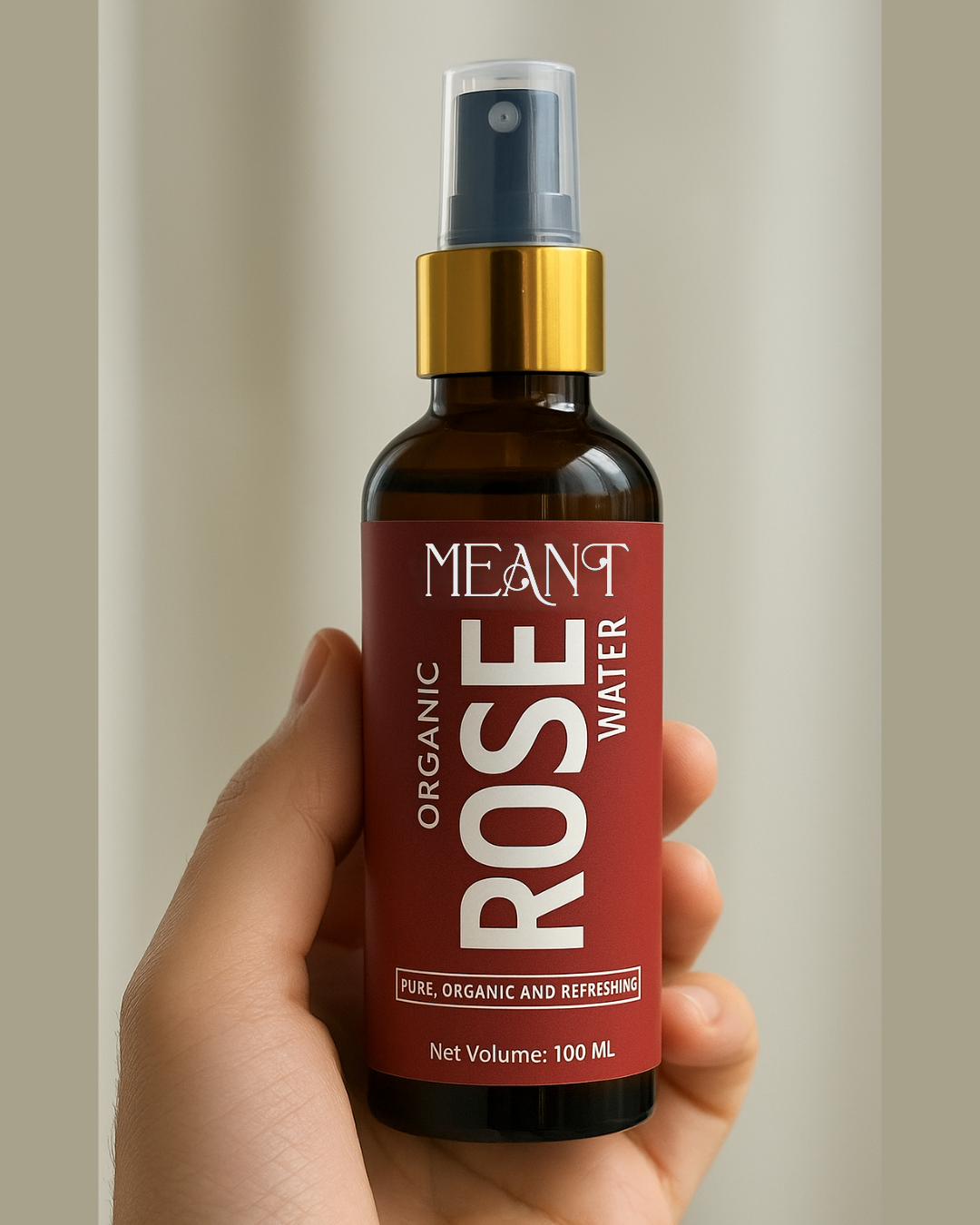 Bottle of MEANT Organic Rose Water held in a hand against a neutral baclground