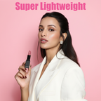 Model holding a MEANT Her Highness lipstick with 'Super Lightweight' text on a pink background.