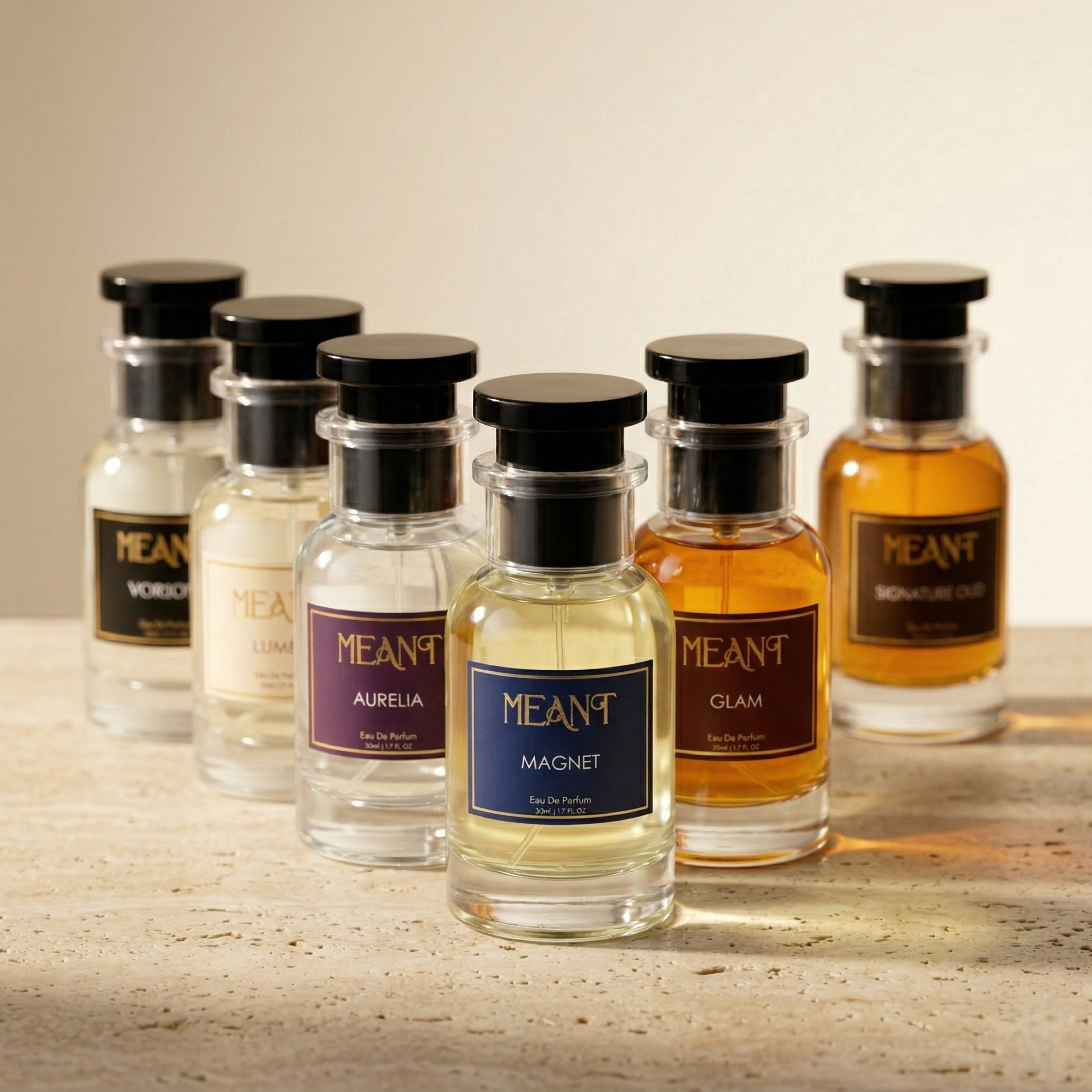 Collection of MEANT perfume bottles on a wooden surface