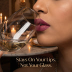 Woman holding a glass of white wine with meant's elizabeth liquid lipstick applied on her lips showing transfer proof quality of Meant liquid lipstick set